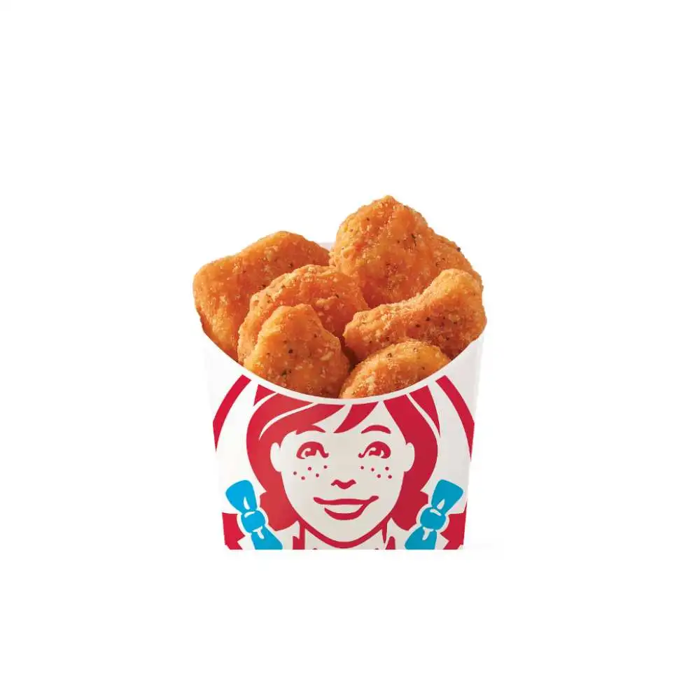 Wendy's Canada golden Crispy Chicken Nuggets – fresh hot all-white meat chicken pieces with crunchy breading, piled high in the classic red cup featuring Wendy's fun smiling logo, perfect juicy snack or side from the value menu