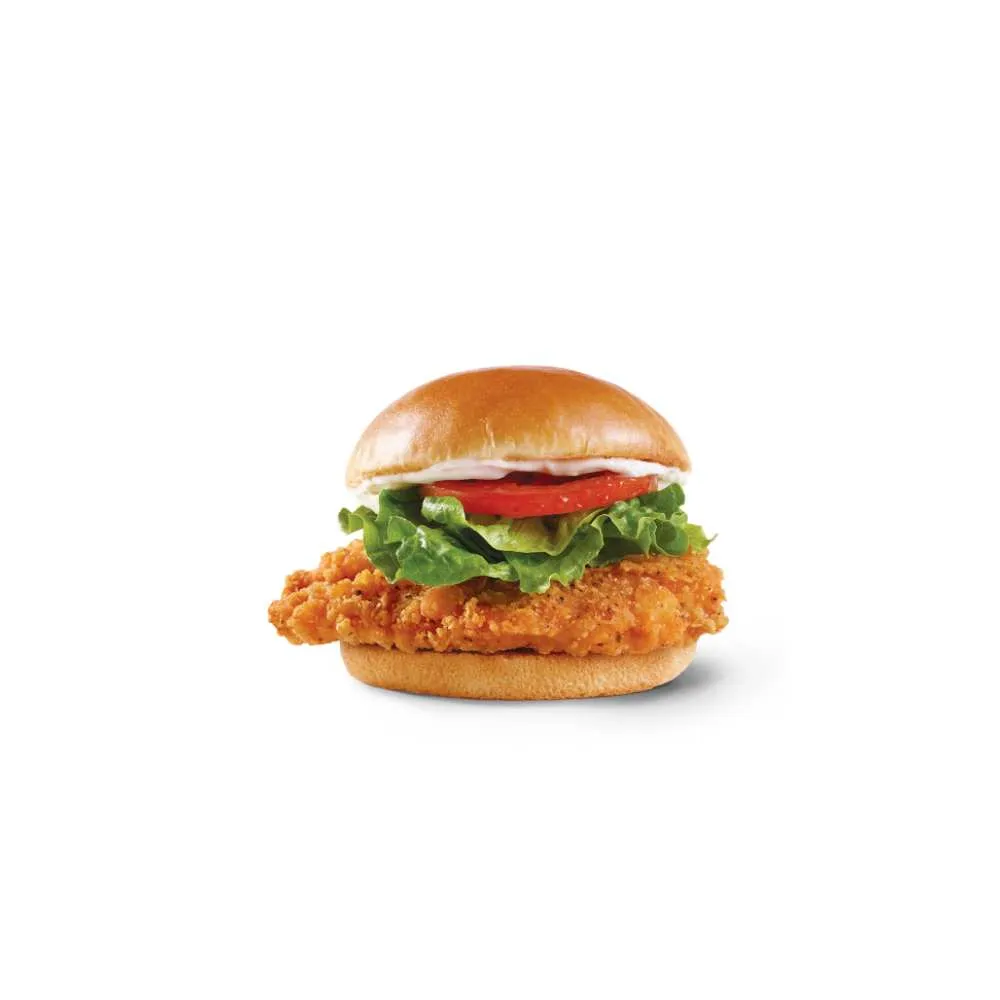 Wendy's Canada Crispy Chicken Sandwich – juicy 100% Canadian chicken fillet with savoury golden crispy breading, topped with fresh crisp lettuce and ripe tomato slice on a soft toasted bun, bold value menu item available all day for craveable fast food flavor